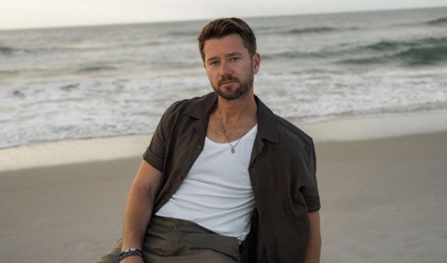 Image Source: https://images.discovery-prod.axs.com/2025/09/adam-doleac_09-05-25_19_68bb5713097d8.jpg